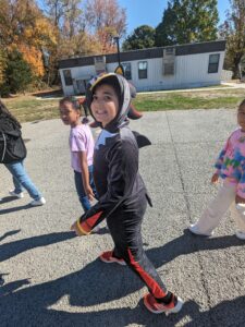 A fourth grade student participating in the fall parade