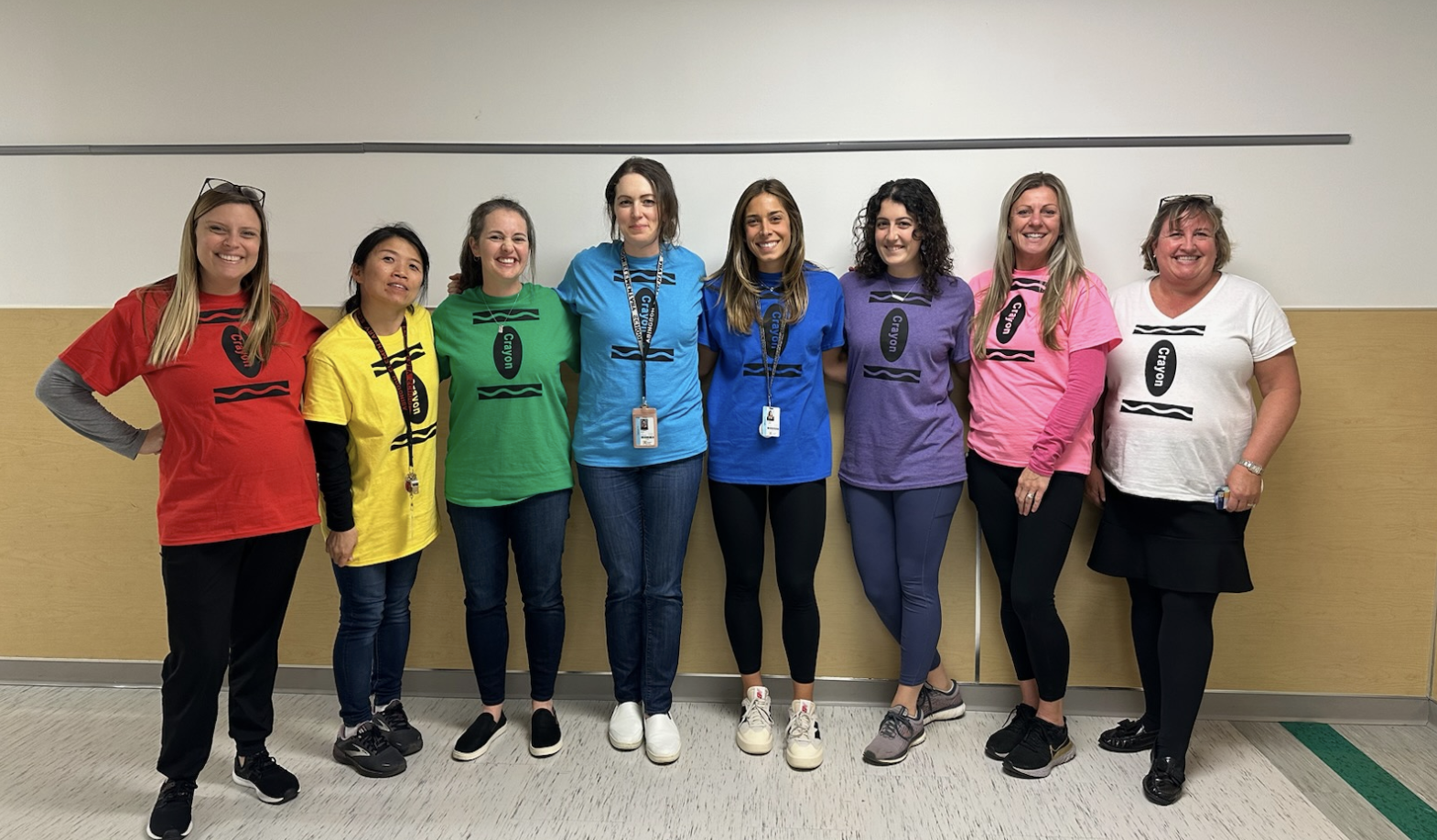 First grade teachers wearing different colored crayon shirts
